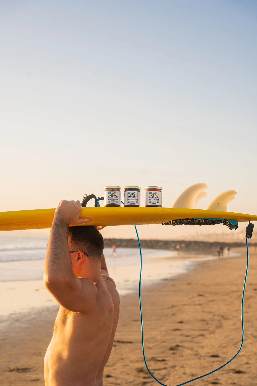Dan carrying surfboard with jars